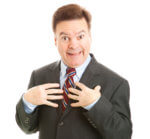 Businessman Looking Surprised And Pointing To Himself As If To Say "who Me?" Isolated On White.